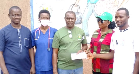 Frederick Wugaa (right), Vice Chairman of the Paga Youth Movement, and Samitu Kumuriwo (2nd from right), Treasurer of the Paga Youth Movement, presenting the cash to John Bosco Asobayire, Head of Finance at the Paga Hospital. With them are Dr Ama Antwiwaa Adu Appiah, and Alhassan Sualisu Halsung (left), Head of Human Resource at the Paga hospital