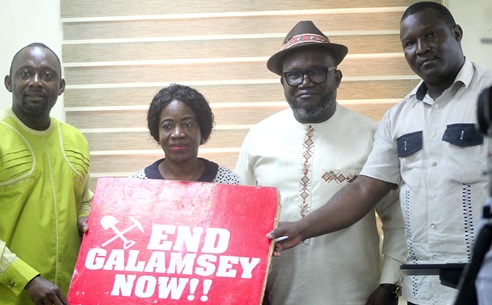 Kenneth Ashigbey (2nd from right), Convenor of GCAG, with some members of the coalition,  showcasing a placard after the meeting. Picture: ESTHER ADJORKOR ADJEI 