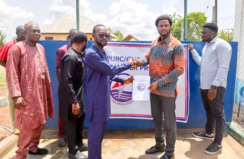 Mohammed Awal Khalilillahi (2nd from right), Northern Regional PURC PRO, handing over the facilities to Mashud Alhassan (3rd from left), Deputy Coordinating Director of Karaga Municipal Assembly