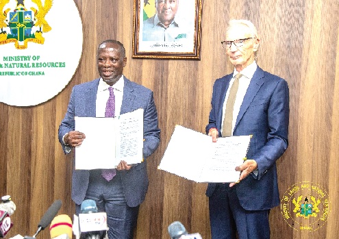 Emmanuel Armah-Kofi Buah (left), Minister of Lands and Natural Resources, and David Tait, Chief Executive Officer of the World Gold Council, displaying the signed MoU after the ceremony