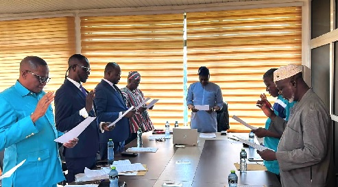 Ibrahim Tia (middle), North-East Regional Minister, swearing in the ICOUR board members