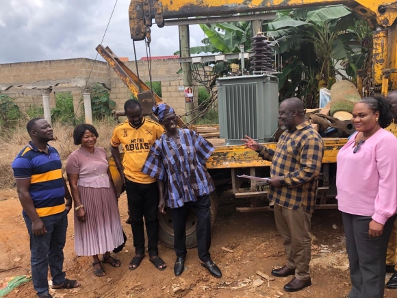 William Adzowu(2nd from right), MCE for Obuasi East, makes a remark when handing over documents to the new transformer(behind) to John Carr(in smock), the Head of Family, Asonkore, in the presence of Celestine Essel(right), acting District Manager of the ECG, and some residents. Picture: EMMANUEL BAAH