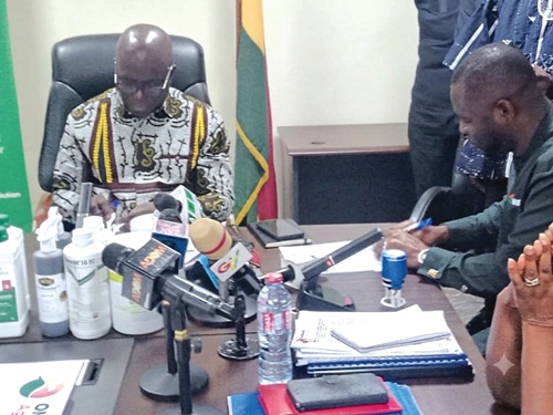 Eric Opoku (left), Minister of Food and Agriculture, signing the MoU with Bernard Oduro Takyi, CEO, Omanbapa AgriTech Ltd.