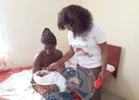 A baby being attended to by a nurse  after taking a vaccination at the Gyangyanadze clinic