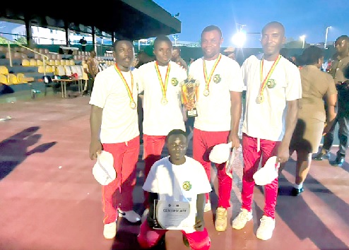 The Ghana Fire Service team proudly display their medals and winner's trophy after capturing the inaugural National Bowls Open Championships title