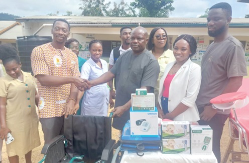 Moses Ayine Asampoa ( 3rd from right), President of the Volta/Oti regional branch of GBA, handing over the medical items to Isaac Annobil, Director of Health Services, Jasikan. Looking on are Jemimah Addo, Welfare Officer of GBA, and staff of the Teteman CHPS compound