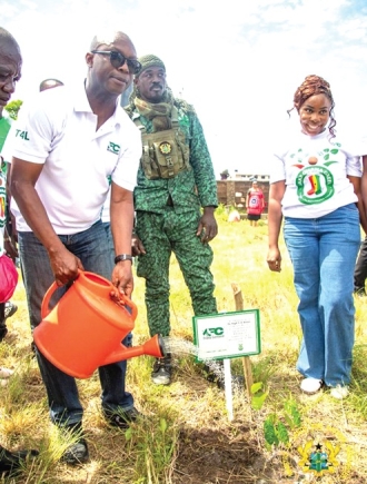 Dr Hugh C.A Brown (left), Chief Executive of the Forestry Commission, planting a tree to mark World Environment Day