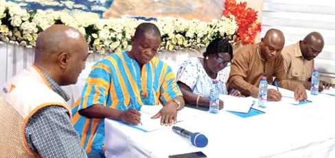 FROM RIGHT: James Ayamwego, Bawku West DCE; John Abugba Abaare, DCE, Garu; Anne Musah, DCE, Buisila South, and Joseph Mbilla, DCE, Tempane, signing the MoU while Robel Wamisho, (left), Associate Director for WASH at World Vision Ghana, looks on
