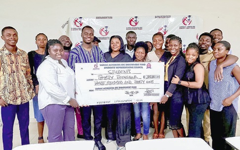 Moses Desire Kouyo (3rd from left), President, Students’ Representative Council, UniMAC, presenting the dummy cheque to some of the beneficiaries