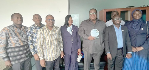 Dr George Eduful (with his citation), the Chief Executive Officer of Power Telco Business Limited. With him are Mr Wonder Davor (2nd from right) and other members of the IET-GH
