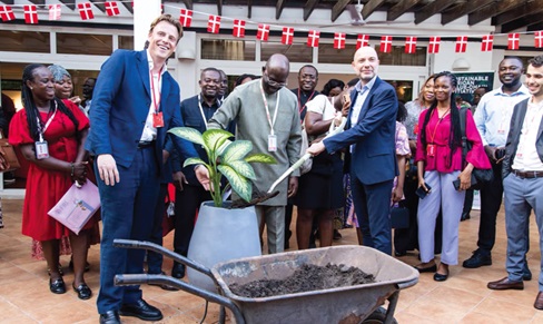 Kofi Nsiah-Poku (middle), President of AGI, being assisted by Jakob Linulf (right), Danish Ambassador to Ghana; Tobias Hansen (left), Programme Manager of SAVI at DI, and other dignitaries to plant a flower to launch the SAVI in Ghana