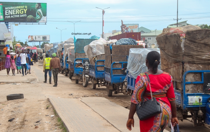 A queue of tricycles awaiting their turn in an alley towards the dumpsite A queue of tricycles awaiting their turn in an alley towards the dumpsite