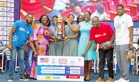 Members of the Accra Girls SHS winning team and some organisers of the programme with the ACE Spoken Word trophy 