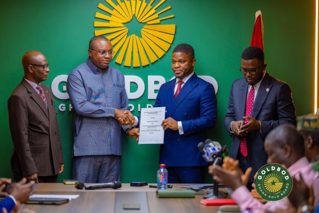 Sammy Gyamfi (2nd from right), CEO, GoldBod, exchanging the agreement with Ernest Brogya Genfi, Deputy Minister of Defence