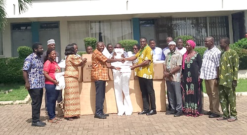 Dr Akisibadek Afoko (left),  Medical Director of Tamale Urology and Modern Surgical Centre, presenting the items to Dr Chrysantus Kubio (right), Northern Regional Director of Health 