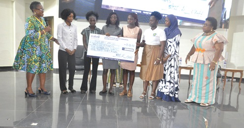 Professor Margaret Gyapong (left), former Director of the Institute of Health Research, UHAS, presenting the cheque for the scholarships to the beneficiaries while Professor Lydia Aziato ( right), Vice-Chancellor of UHAS, look on