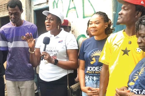Madam Adofo ( with mic) addressing the residents