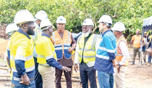 Issah Salifu Taylor (2nd from right), MP for Tarkwa Nsuaem, and Sun Yuanwei (right), Deputy Managing Director of Ghana Manganese Company, interacting with workers at the site for the refinery