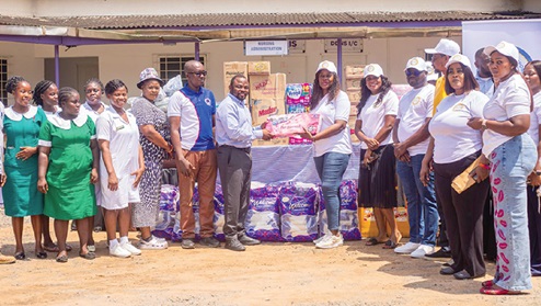 Maria Edith Oquaye (5th from right), Director of Corporate Affairs, NPA, presenting the items to Dr Joseph Atsutse Agbenyegah, Medical Officer, Accra Psychiatric Hospital