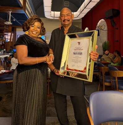 Ben Brako presenting the citation to Elizabeth