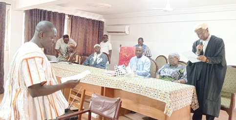 Lambert Akunzebe (left), Presiding Member-elect, Bolgatanga Municipal Assembly, being sworn in by Justice Ernest Pascal Gemadzie, Upper East Regional Supervising High Court Judge