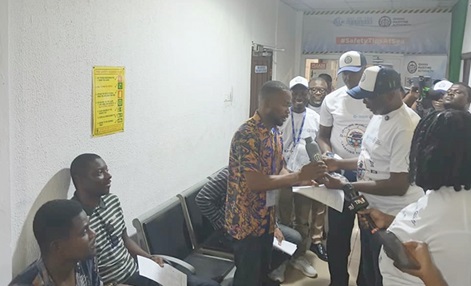 Dr Kamal-Deen Ali (2nd from right), Director General of the Ghana' Maritime Authority, presenting a souvenir to Frank Iniobong Gregory, a Nigerian Seafarer, who had come to the Tema office of the GMA to complete a documentation process