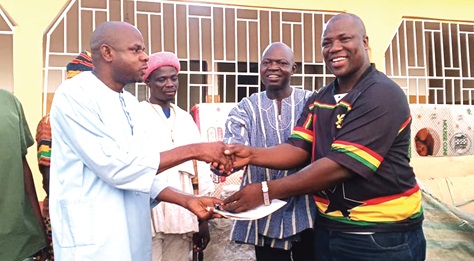 Alhassan Seidu Alajor (right), MP for Chereponi, presenting the keys of a CHPS compound at Adali to Yakubu Abdul-Rahama, District Director of Health Services. With them is Sheini Kofi Amadu (2nd from right), DCE for Chereponi