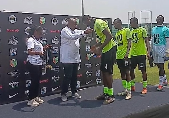 Mr Samuel Aboabire presenting medals to players of inaugural Roc Cup champions, SOAR Academy of Guinea