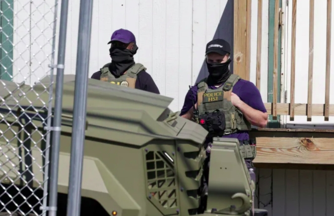 US Immigration and Customs Enforcement (ICE) agents stand guard in Newark, NJ, US [File: Jeenah Moon/Reuters]