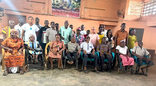 Joseph Atsu Homadzi (middle), National President, Ghana Federation of Disability Organisations, with some PWDs after the visit   	                  