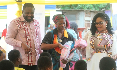Paul Afotey Quaye (left), the Municipal Chief Executive for Krowor, and  Dr Agnes Naa Momo Lartey (right), Minister for Gender, Children, and Social Protection, distributing sanitary pads to some students and residents of Nungua. Picture: ESTHER ADJORKOR ADJEI 