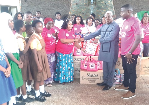Benjamin Ayiku (2nd from right), Member of Parliament for Ledzokuku, in a handshake with Theresa Tetteh, Ledzokuku Municipal Director of Education, during the presentation of the sanitary pads