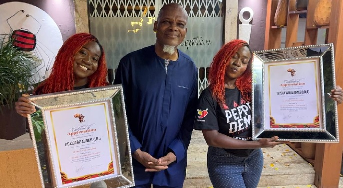 Mr Henry Holbrook-Smith (middle), Associate Director of DreamChild Foundation flanked by Lali x Lola, after the music duo were presented with the awards of appreciation