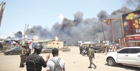 Personnel of various security agencies assessing the fire situation. Pictures: Caleb Vanderpuye