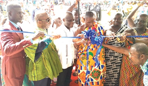 Pe Aboatea (3rd from right), acting President of the Banda Traditional Area, being assisted by Ahmed Ibrahim (3rd from left), MP for Banda, Dr Victor Asare Bampoe (2nd from left), Chief Executive Officer of the NHIA, and Peter Dongi (left), Banda District Chief Executive, to cut the tape to inaugurate the facility. INEST: The facility
