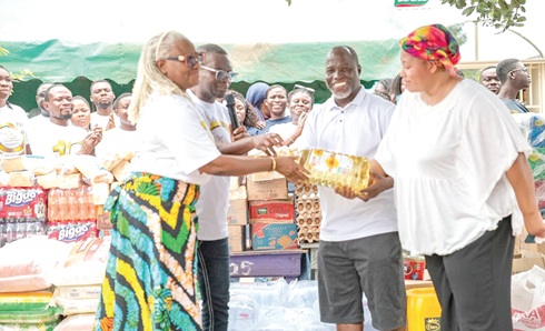 Apostle Derek Amanor (2nd from left) and Rev. Dela Amanor (left) presenting the items to Rev. John Azumah (2nd from right), the CEO of the orphange