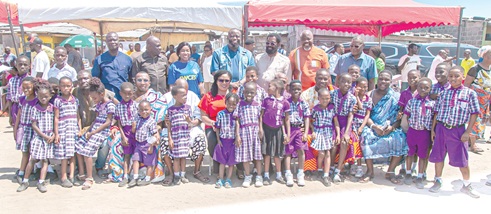 Agnes Naa Momo Lartey (arrowed), Minister for Gender, Children and Social Protection, and Dr Alfred Okoe Vanderpuije (standing, 5th from left), MP for Ablekuma South, with traditional leaders, schoolchildren and other participants in the community dialogue on social protection at Chorkor in Accra