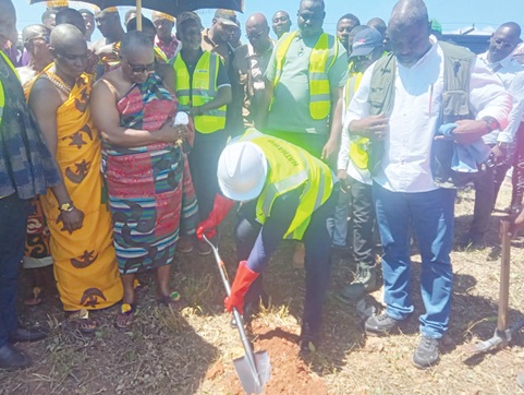 Eric Opoku, Minister of Food and Agriculture, cutting the sod for work to begin on the project at Anunuso. Looking on are Nathaniel Adams (right), Project Coordinator, FSRP, and some of the guests
