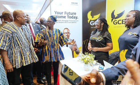 President John Dramani Mahama (left), Prosper Hoetu, CEO, NHF; and other dignitaries touring some exhibition booths at the 2026 National Conference on Housing Finance in Accra