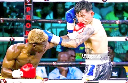Theophilus Kpakpo Allotey (left) punishes David Facundo Garcia during the fight in Accra last month 