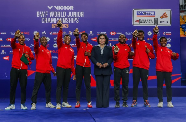 Players of Golden Shuttlers celebrating their historic win with their trophies
