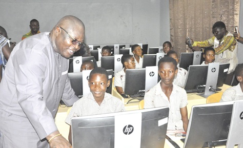 Mawutor Agbavitor, Volta Regional Chairman of the NDC, being taken through a programme by a learner at the school