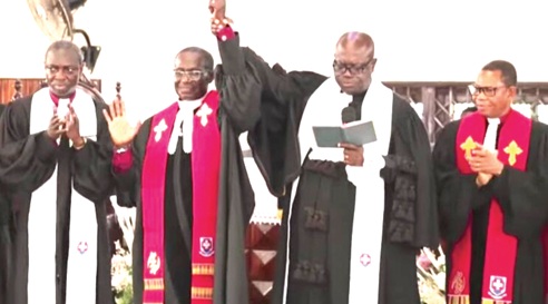 Rt Rev. Dr Abraham Nana Opare Kwakye (right), Moderator of the Presbyterian Church of Ghana, introducing Rev. David Sowateye Obli, new Chairperson of the Ga West Presbytery, to the congregation after his induction. With him is Rev. David Aboagye-Danquah, Clerk of the General Assembly of the PCG