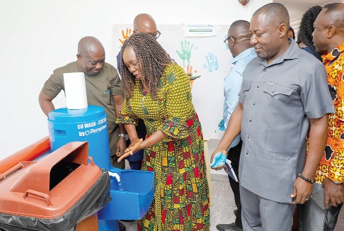 Rita Naa Odoley Sowah (left), Deputy Minister of Local Government, Chieftaincy and Religious Affairs, demonstrating how to wash hands properly during the commemoration  of the  Global Handwashing Day.  Picture: ELVIS NII NOI DOWUONA 