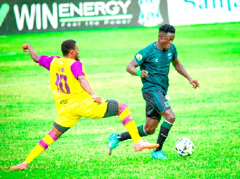 FC Samartex forward Akwasi Saepong is challenged by Nana Kofi Babil (left) of Medeama during yesterday's regional derby in Samreboi