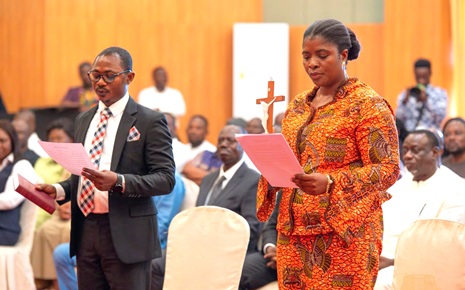 Emelia Afi Agbenyo (right) and Joseph Kwaku Asamoah (left), the two new appointed Deputy Commissioners of the Electoral Commission,  taking their oath of office