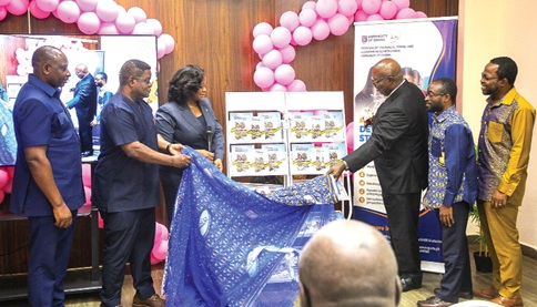 Belinda Boamah (3rd from left), Deputy Managing Director of Business and Operations at the National Investment Bank, being assisted by Prof. Robert Osei Darko (3rd from right), Director of the Institute of Statistical, Social and Economic Research (ISSER); Prof. Fred Dzanku (right), Head of Economics Division at ISSER, and other officials, to unveil the 2026 State of the Ghanaian Economy Report at the launch by ISSER at the University of Ghana. Picture: CALEB VANDERPUYE