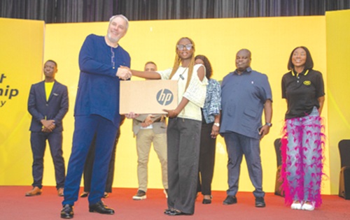 Stephen Blewett (left), Chief Executive Officer, MTN Ghana, presenting a laptop to one of the beneficiary students. Picture: DOUGLAS ANANE-FRIMPONG