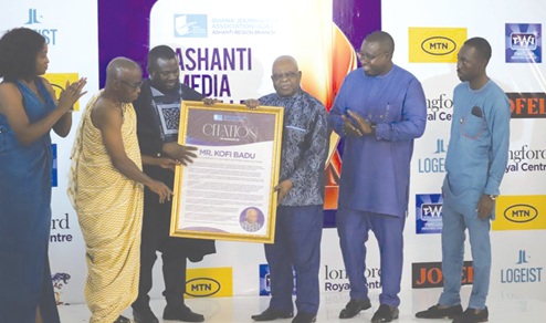 Albert Kwabena Dwumfuor (3rd from left),  President of the GJA, being assisted by Yaw Boadu Ayeboafoh (2nd from left), a former Editor, Daily Graphic, to present a citation to Kofi Badu (3rd from right), the Chief of Staff at the Manhyia Palace. Those applauding include Kofi Adu Domfeh (2nd from right), Ashanti Regional Chairman, GJA Pictures: EMMANUEL BAAH
