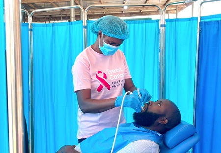 A beneficiary undergoing dental checks at the health screening